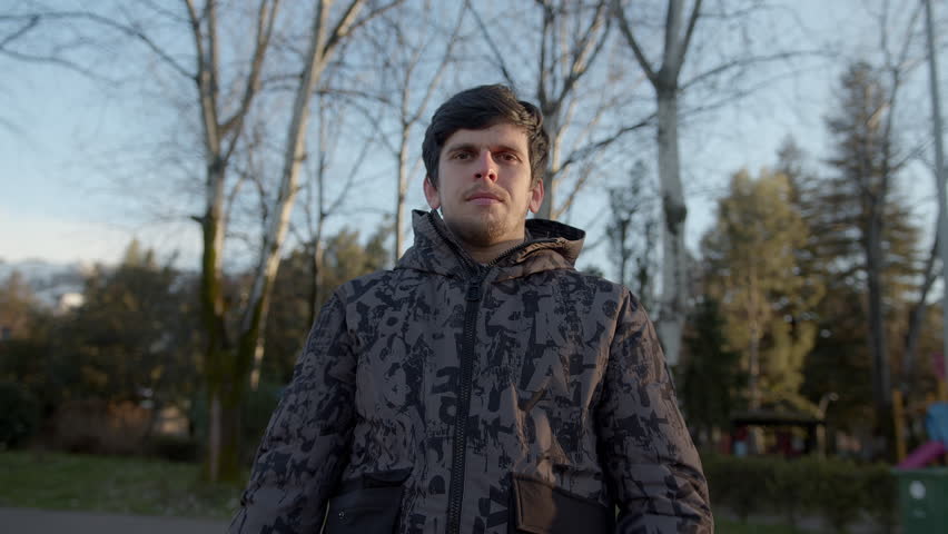 Stylish Young Man in a Winter Coat He Crossing Arms Posing Outdoors for the Camera