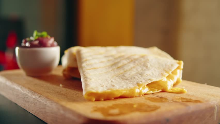 Close up of cheese quesadilla, Eating Traditional Mexican food, tex mex cuisine. Hands taking cooked quesadilla with vegan pork beef meat and vegetables,  Royalty-Free Stock Footage #1100470325