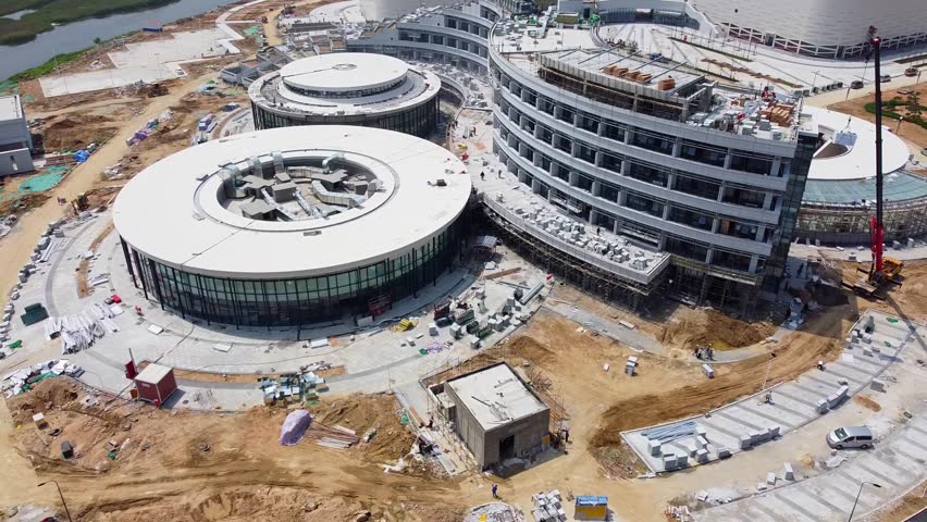 Weihai Olympic center hotel section with busy works - Nanhai New District, China.