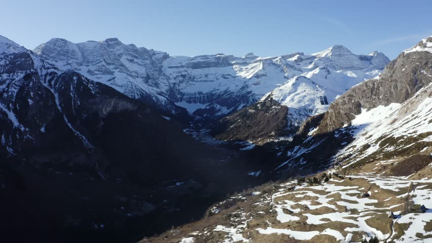 Aerial View of the "Cirque de Gavarnie" in the Pyrenees mountains, France, A formidable and beautiful wall of ice and rock looms in the background, the village of Gavarnie is in the valley below