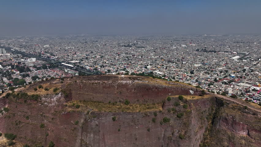 Aerial view over a mountain, overlooking endless amount of poor residential areas of Mexico city