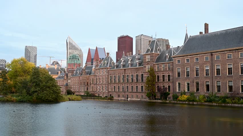 Den Hague, Netherlands. The Binnenhof complex in the city centre of The Hague, Holland. Gothic castle and lake.