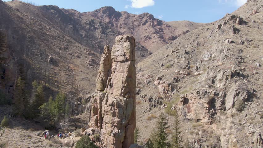 Orbiting drone shot of a popular climbing rock in Fort Collins, Colorado.