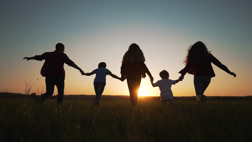 Happy family silhouette outdoors in park. family runs at sunset hand in hand together. family runs at sunset with children. Happy children father run in nature. Happy walk in park holding hand father. Royalty-Free Stock Footage #1100477611