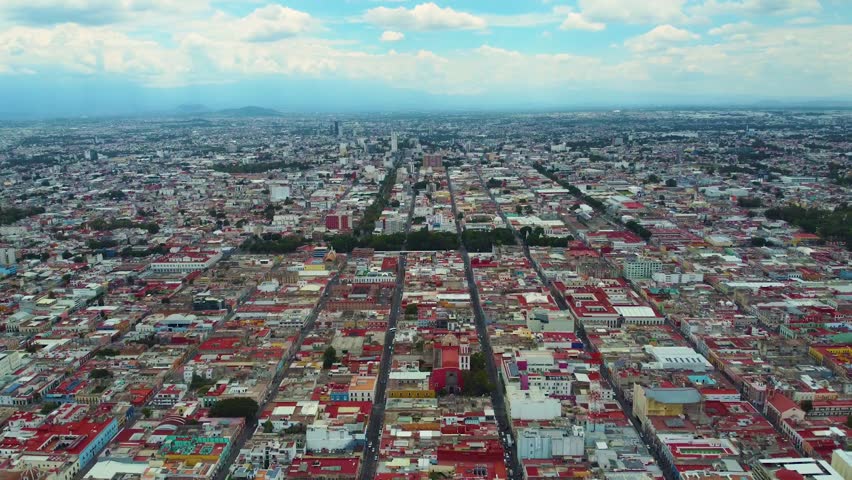 Stunning aerial views of Cholula, Puebla captured by drone. Fly over the city center, magnificent churches, cathedrals and its breathtaking landscape. Perfect for stock video content.