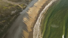 Family day in Playa Grande Beach with kids playing at sunset, Uruguay. Aerial top-down view