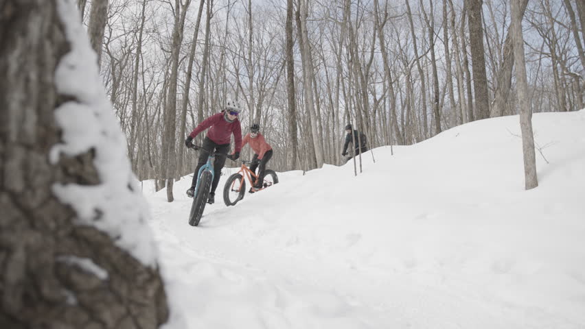Female cyclists racing on fatbikes in the winter Royalty-Free Stock Footage #1100480993