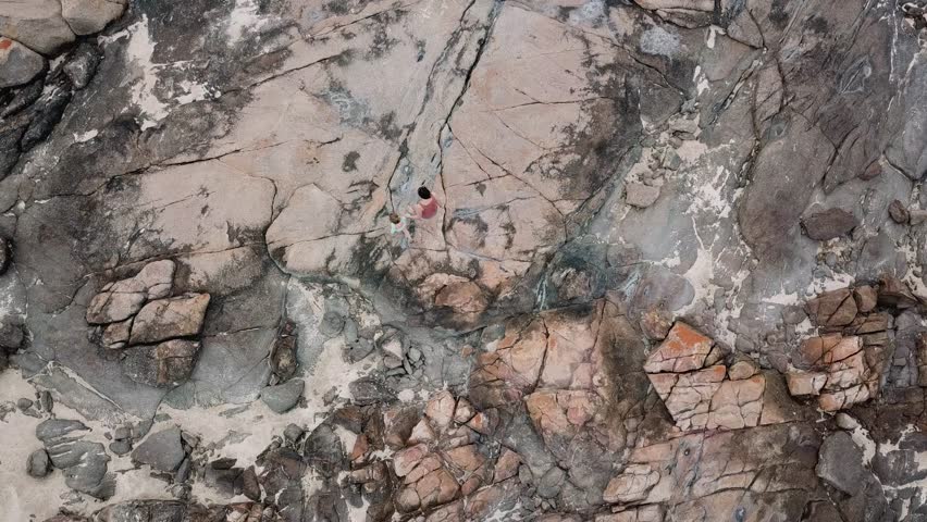 Birds Eye View of Mother and Child Walking Next to Rockpools, Rising Aerial