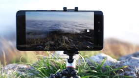 Fast motion mobile phone screen recording time lapse of beautiful moving clouds from above. Capturing amazing winter nature videos on a mountain peak with smart phone camera. Modern technology concept