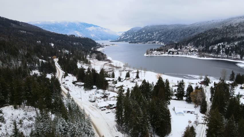 Snowy Wonderland of Adams Lake and Mountainous Forests, Drone Flight Overhead