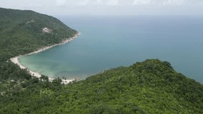 Aerial video on the top of the rocky mountain admiring the view of the sea and the rainforest. Drone view