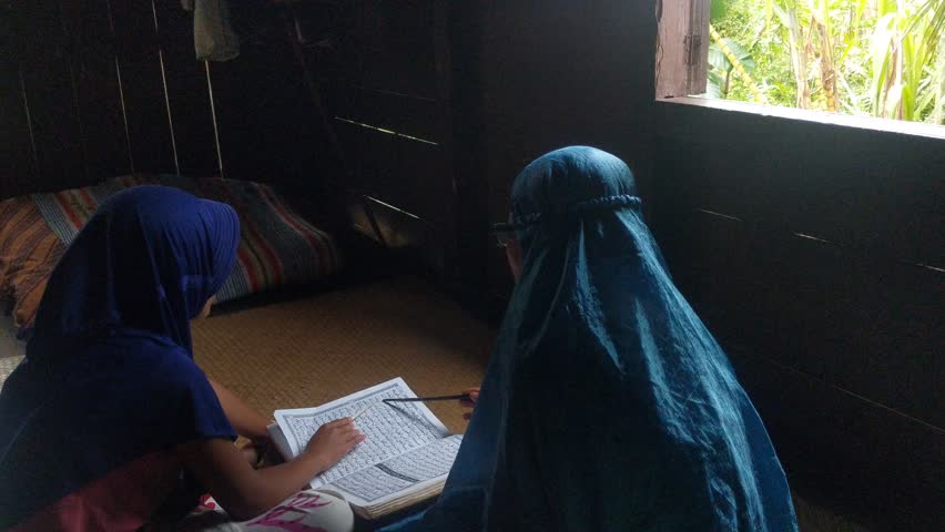 children learn to read the Koran with a female teacher