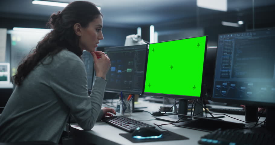 Female Software Developer Working on a Desktop Computer with Green Screen Mock Up Display. Specialist Typing on Keyboard, Coding and Implementing a New Technical Feature, Working in an Agency Royalty-Free Stock Footage #1100488283