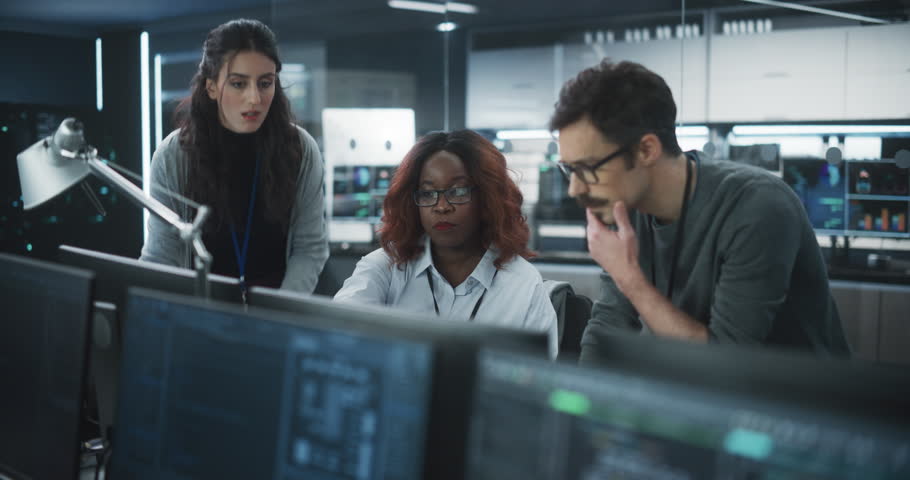 Team of Three Multiethnic Diverse Software Developers Talk, Discuss an AI Project. Empowered Black Female Specialists and Two Colleagues Work on Digital E-Commerce Startup Business