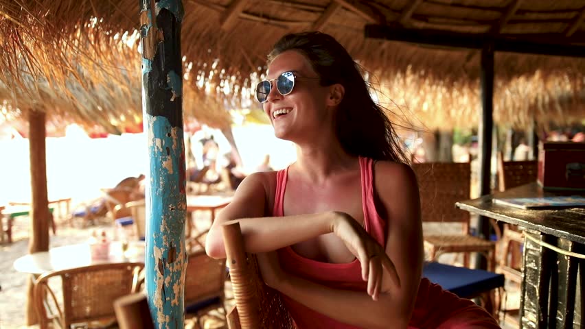 Woman wearing sunglasses sitting in the beach bar during hot summer day Royalty-Free Stock Footage #1100492151