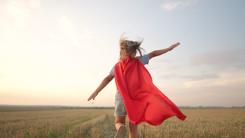 Kid superhero run. girl daughter happy family a dream concept. baby girl superhero run in red cape at sunset. portrait child superhero in the park. strength fantasy lifestyle concept | Shutterstock HD Video #1100493483
