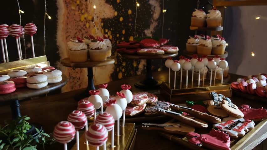 Sweets and cupcakes on the festive table with snacks on the buffet table
 | Shutterstock HD Video #1100493549