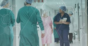 Animation of medical data over diverse female doctor and patient talking in busy hospital corridor. Medical and healthcare services concept digitally generated video.