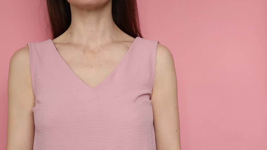 Embrace equity. Woman hug yourself dressed pastel pink dress on pink background. International women's day concept. Pastel colors, copy space. Royalty-Free Stock Footage #1100495773