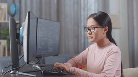 Asian Teen Girl Programmer Smiling To Camera While Creating Software Engineer Developing App, Program, Video Game On Desktop Computer At Home. Terminal With Coding Language 
