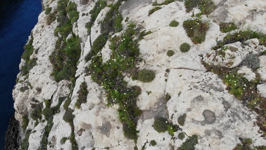View from cliff down to river flyover in Gozo, Ghasri, Malta island