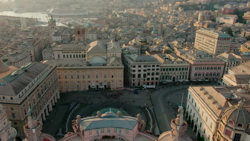 Establishing aerial panorama of Central Genoa City, Italy, Europe. Landmark Piazza De Ferrari with Opera and Palace of the Doges at sunset. Urban Travel and Architecture concept. 4K orbit drone shot Royalty-Free Stock Footage #1100501269