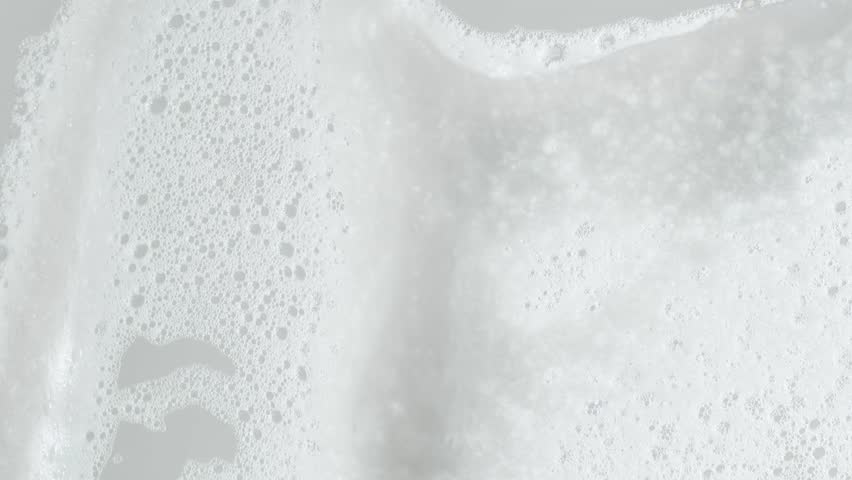 Soap foam moving in white background, natural shampoo white bubbles motion, slow motion, 8K downscale, 4K. Royalty-Free Stock Footage #1100502335