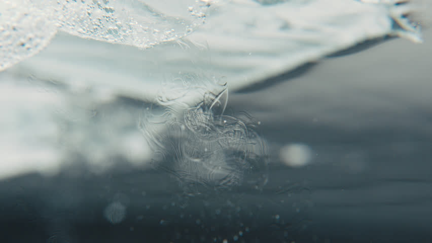 Abstract oil floats from plastic in water | Shutterstock HD Video #1100503735