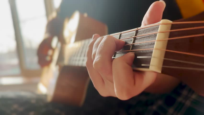 Classic guitar girl play. musician jazz acoustic a instrument concept. guitarist country girl hands close-up plays at the window indoors. learning to play lifestyle the guitar Royalty-Free Stock Footage #1100503831