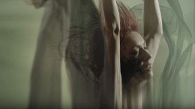 Art dance moves with long fabrics . Few shots of the powerful psychological contemporary ballet dancing movements with large textile materials . People dancing , flying , jumping  . Growth of cloth - Powered by Shutterstock - Get 15% off with code: PIKWIZARD15