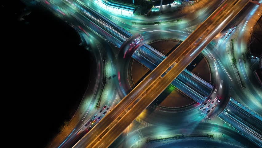 Hyperlapse time-lapse of car traffic transportation above circle roundabout road in Asian city. Drone aerial view fly in circle, high angle. Public transport or commuter city life concept	 | Shutterstock HD Video #1100510751