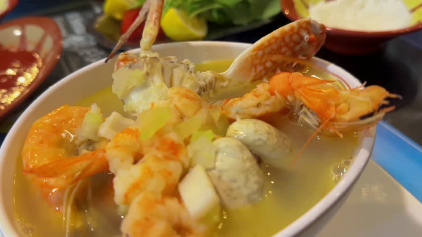 seafood soup in a white cup in a restaurant, shrimp and crab soup