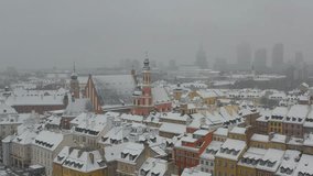 Aerial view of the winter snowy city skyline. Snowfall in the city. Warsaw, Poland.  Warsaw Old Town (Stare Miasto) Downtown skyline. Skyscrapers. The roofs of the houses are covered with snow.