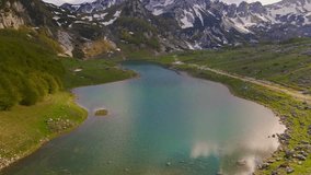 This stunning drone shot captures the breathtaking beauty of Durmitor National Park in the northern part of Montenegro. The aerial view, captured by a drone, offers a breathtaking perspective on the