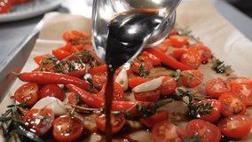 Cooking sun-dried tomatoes. Chef pouring olive oil o sliced cherry tomatoes. Slow motion. High end restaurant. Traditional Italian cuisine. Sliced halves of ripe fresh red tomatoes lie on a baking - Powered by Shutterstock - Get 15% off with code: PIKWIZARD15