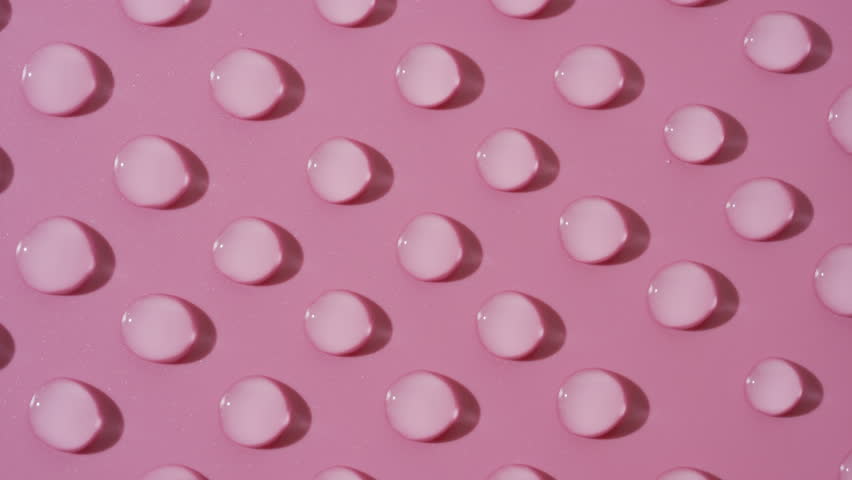 Top view macro shot of moving transparent drops on pink background | Abstract skin care gel ingredients formulating concept | Shutterstock HD Video #1100517513