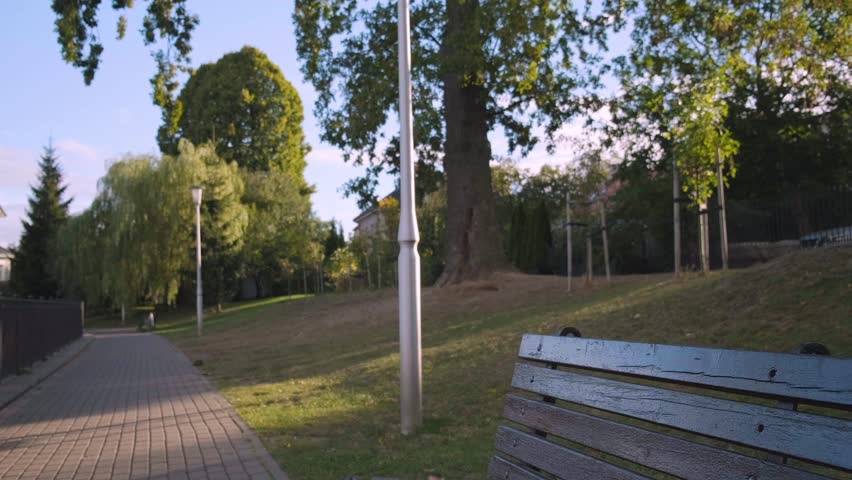 Young Caucasian man sitting outdoors eating lunch box in eco paper package. Takeaway food or food delivery and takeout concept