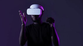 African American guy in Smart glasses of virtual reality. Augmented reality game, future technology, AI concept. VR. Neon light.