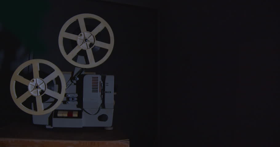 Vintage movie projector playing a film. Royalty-Free Stock Footage #1100534051