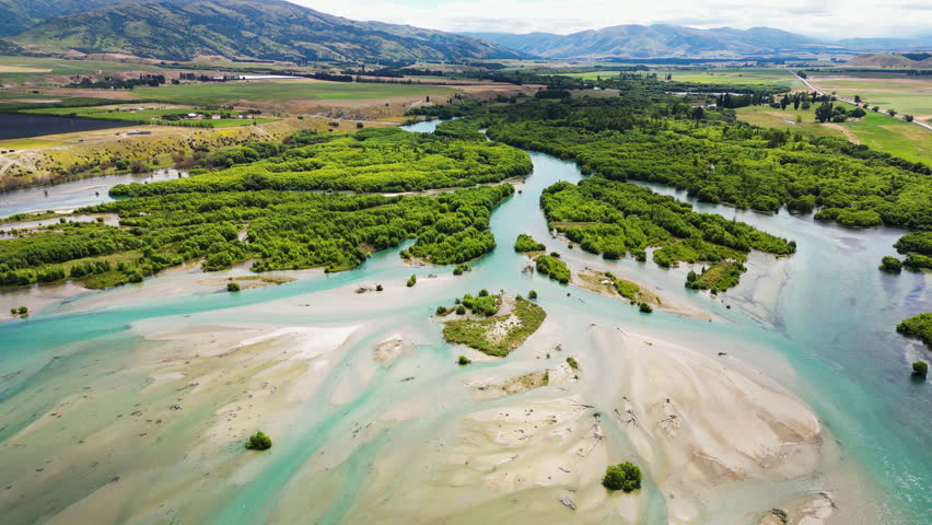 Clutha River With Green Vegetation Near The Bendigo Freedom Camping Ground In New Zealand. - aerial