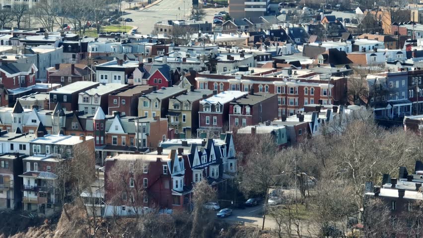 Long aerial zoom of Oakland housing on near University of Pittsburgh campus. College student homes. Drone establishing shot in Pittsburgh, Pennsylvania.