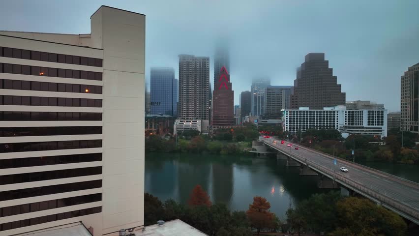 Austin Skyline Covered With Low Clouds At Dusk In Texas, USA. aerial ascend