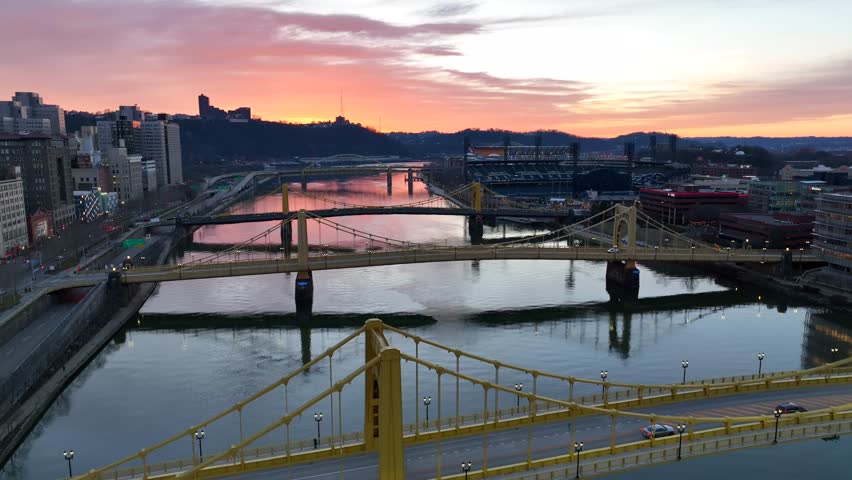 Sunset over three yellow bridges and PNC Park in Pittsburgh Pennsylvania. Roberto Clemente, Andy Warhol, and Rachel Carson bridges over Allegheny River.
