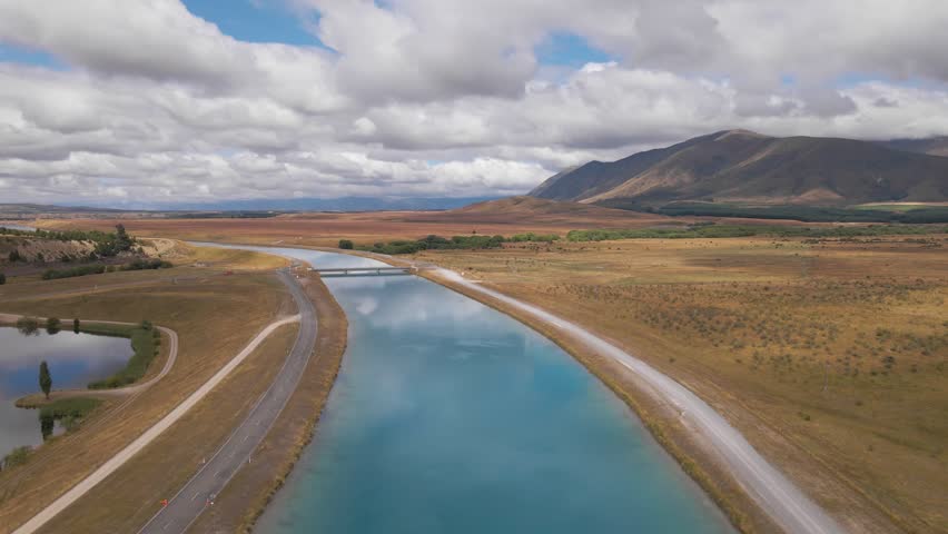 Drone flight over hydro canal in Mackenzie District, panoramic landscape view