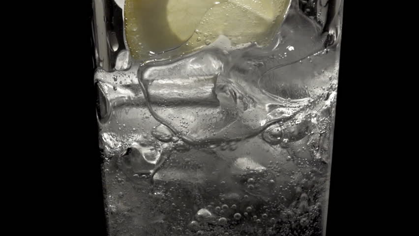 A glass of soda water on ice with slice of lemon close up | Shutterstock HD Video #1100536717
