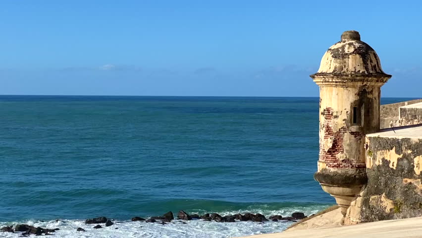Fort wall sentry box above the Caribbean Sea crashing waves. Bartizan or garita at Castillo San Felipe del Morro, San Juan, Puerto Rico. Icon appears on Puerto Rican license plates and quarters. 