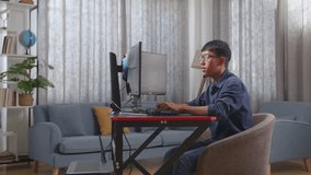 Asian Teen Boy Programmer Celebrating Succeed Creating Software Engineer Developing App, Program, Video Game On Desktop Computer At Home. Terminal With Coding Language 
