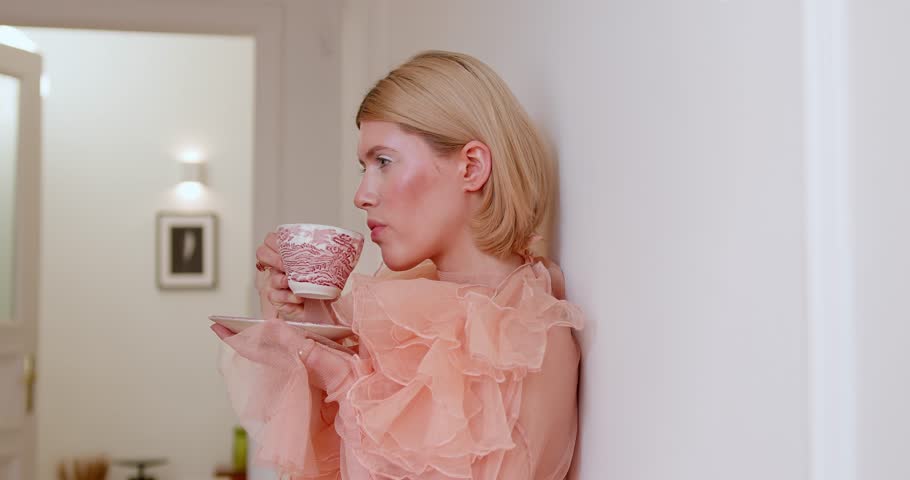 Portrait of a cute European girl in vintage clothes in an apartment with a smile