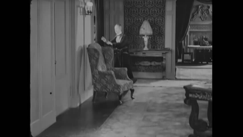 Circa 1926 - in this comedy, a man opens the door to his villa and a woman comes in, giving him a rose. then, she asks for a kiss and closes her eyes.