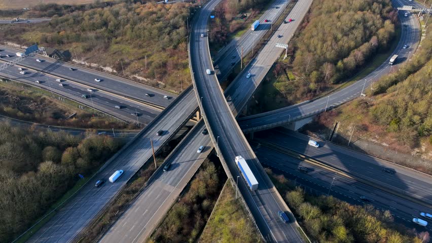 Rush Hour Vehicles Driving on a Motorway Interchange UK Aerial View Royalty-Free Stock Footage #1100558497